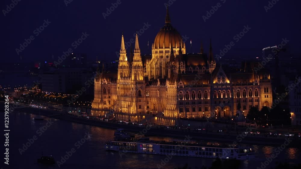 Budapest Parliament Building illuminated at night, reflecting on the Danube River with nearby bridges and city lights. A breathtaking view. 4k video of Budapest, Hungary. Budapest Parliament Building illuminated at night, reflecting on the Danube River with nearby bridges and city lights. A breathtaking view. 4k video of Budapest, Hungary.