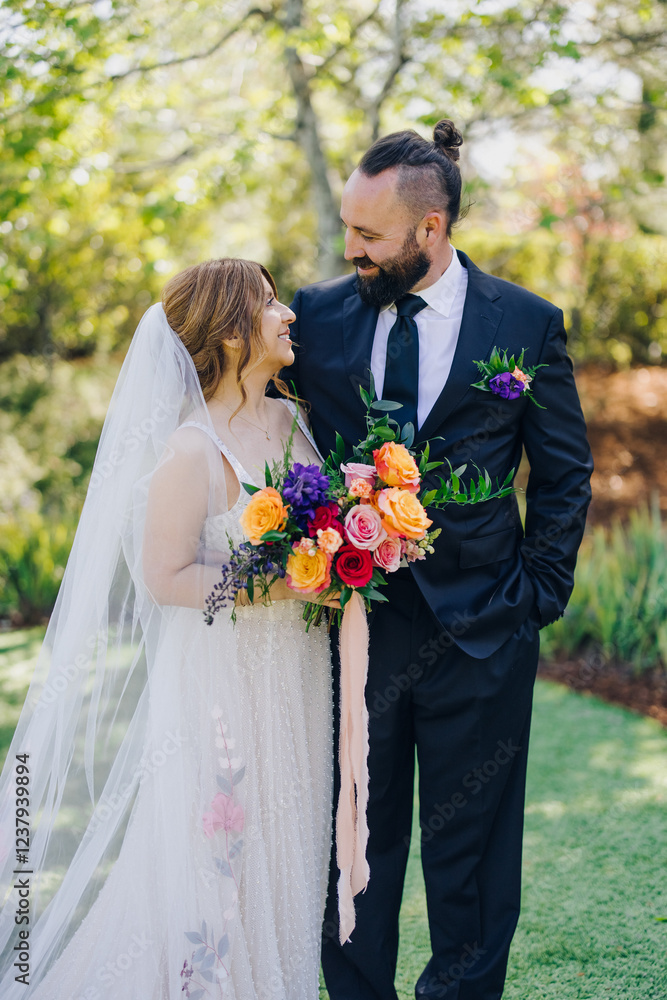 A stunning outdoor wedding features a happy couple exchanging loving glances, surrounded by vibrant flowers in a lush garden, creating a perfect romantic atmosphere of love and joy A stunning outdoor wedding features a happy couple exchanging loving glances, surrounded by vibrant flowers in a lush garden, creating a perfect romantic atmosphere of love and joy
