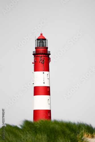 View of the red and white lighthouse on the North Frisian island of Amrum.
 photo