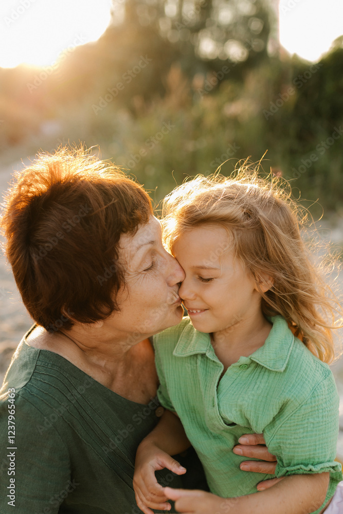 Grandmother kissing granddaughter on nose Grandmother kissing granddaughter on nose