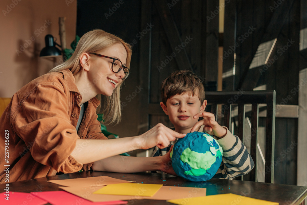 Mother and son sculpting clay Earth at home