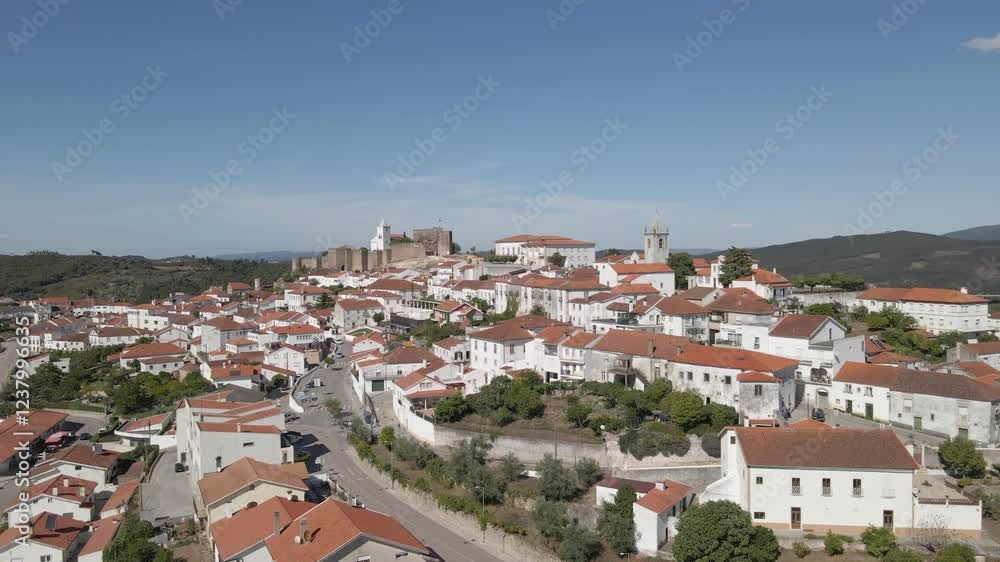 Aerial view of Penela a 1137 municipality of Portugal. Drone slowly rotating to the left showing most of the municipality houses and the church inside the old castle fortifications. Aerial view of Penela a 1137 municipality of Portugal. Drone slowly rotating to the left showing most of the municipality houses and the church inside the old castle fortifications.