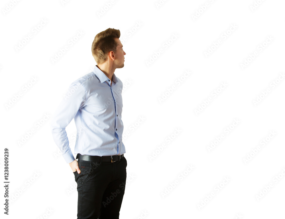 Young man in light blue shirt andpants looking to the side, hands in pockets. Isolated on white background. Concept of casual style Young man in light blue shirt andpants looking to the side, hands in pockets. Isolated on white background. Concept of casual style