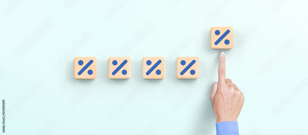 Fototapeta premium Hand choosing increasing percent on wooden cube, Interest rate financial, mortgage rates, profit concept