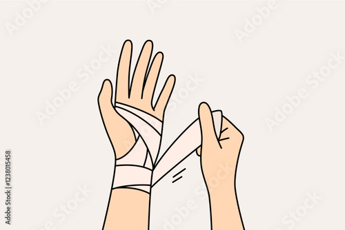 Wrapping bandage around injured arm of person who has suffered fracture or crack in bone after accident. Injured arm of fall or car accident victim needs bracing to speed up rehabilitation.
