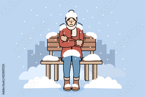 Freezing man sits on bench covered with snow due to lack of home and homeless shelters. Freezing guy is shaking and experiencing chills and needs social assistance to avoid getting sick.