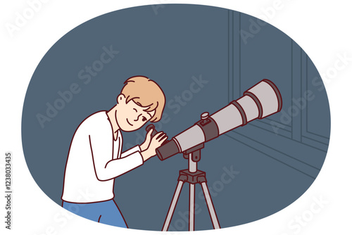 Teenager boy with telescope watches stars and is fond astrology while standing in apartment near window. Child uses telescope wishing to visit space and become astronaut from scientific expeditions