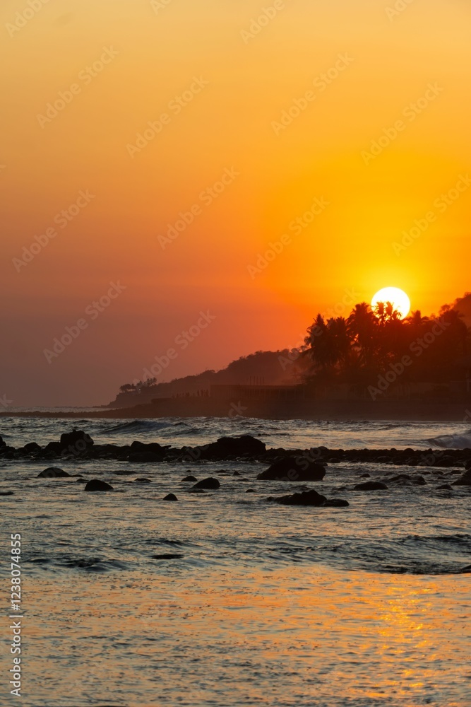 Obraz premium Sunset over Rocky Coastline