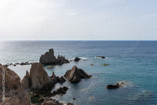 kayaks crossing between the reefs at sea photo