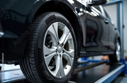 Wallpaper Mural Close-up view of car wheel undergoing maintenance at auto repair shop. Car lifted in garage workshop. Technician checking wheel alignment. Laser sensor equipment used for diagnostics, 3d wheel Torontodigital.ca