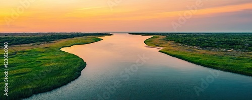 Coastal scenic nature idea. A serene sunset over tranquil river and lush green banks  showcasing nature s beauty.