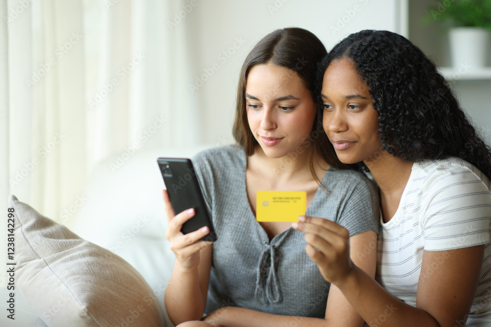 Interracial couple buying online using phone at home Interracial couple buying online using phone at home