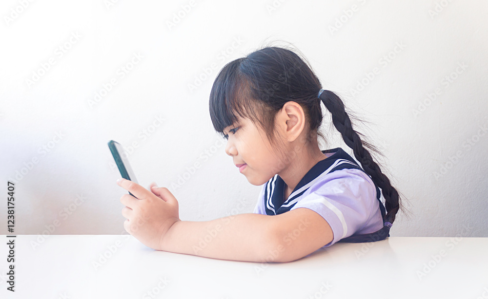 Asian kid girl using smartphone and enjoying content on internet or social media. Asian kid girl using smartphone and enjoying content on internet or social media.