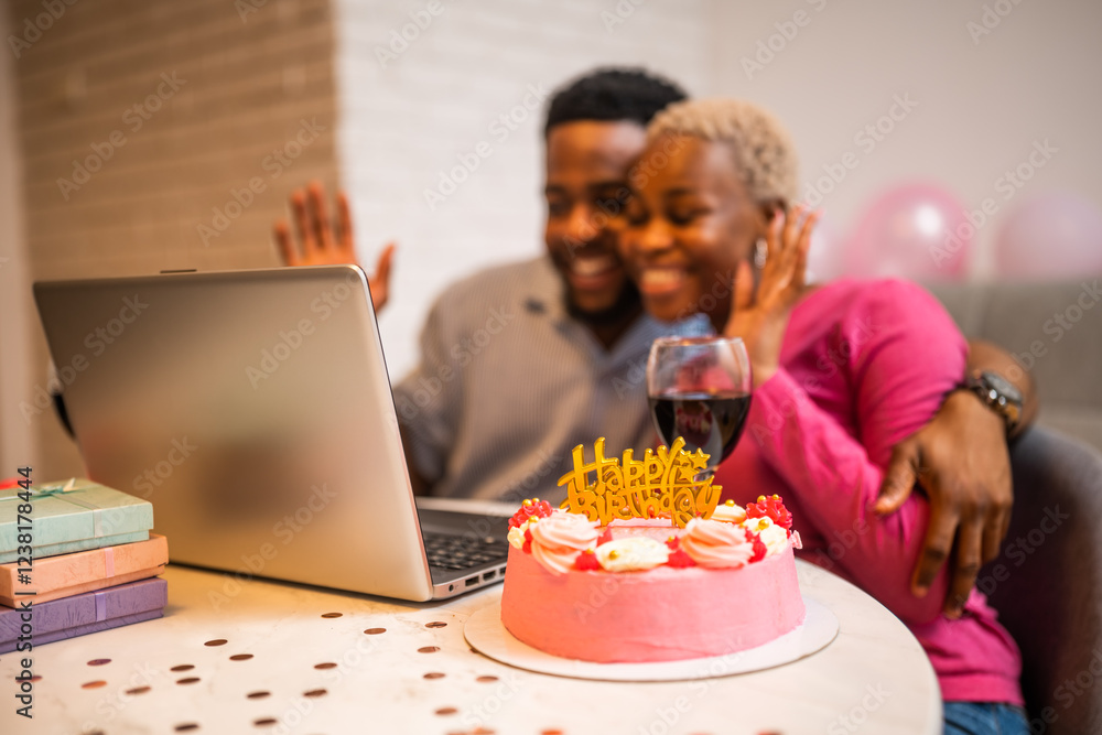 Happy young couple celebrating woman's birthday at home. They are having video call with family. Happy young couple celebrating woman's birthday at home. They are having video call with family.