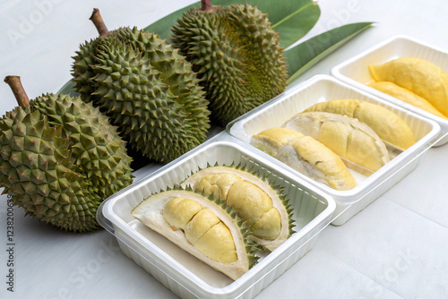 Durian fruit and durian pulp in a box on a white background