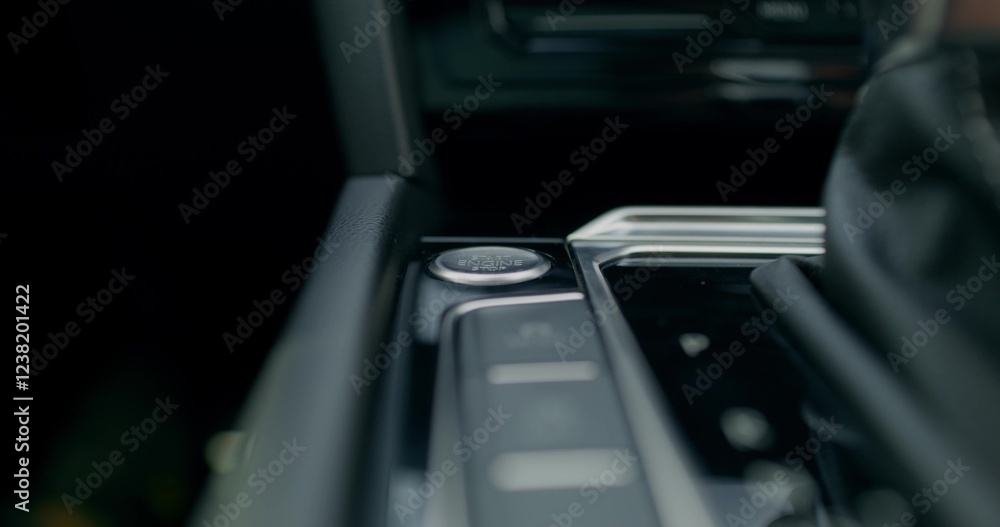 The man presses the keyless start button of the car. Close-up of his hands, an unrecognizable person. View from the car interior. The man presses the keyless start button of the car. Close-up of his hands, an unrecognizable person. View from the car interior.