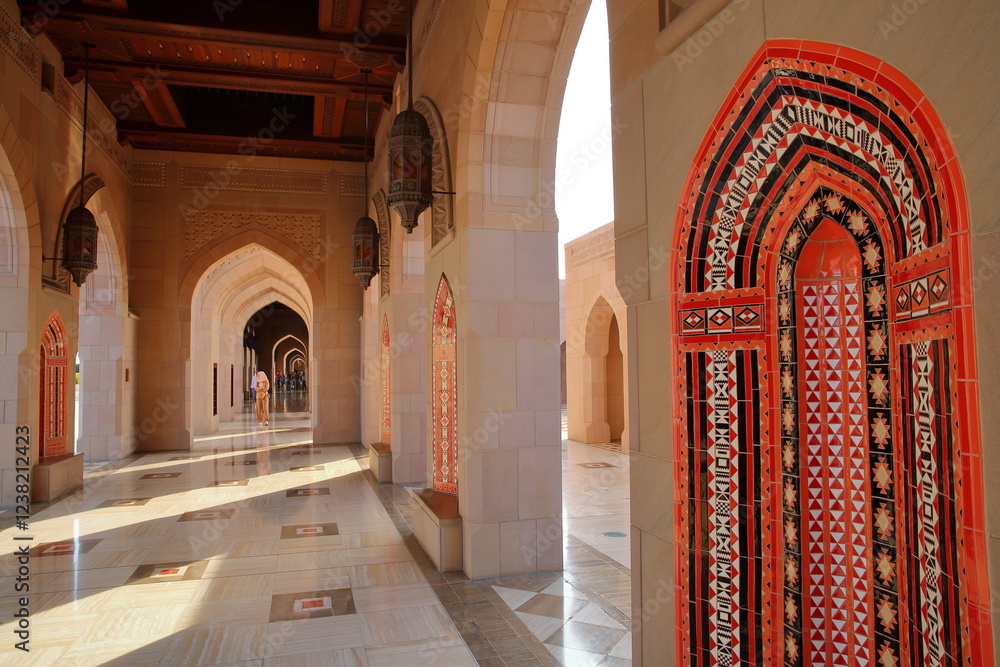The Sultan Qaboos Grand Mosque in Muscat, Oman, with archways and patterned wall tiles