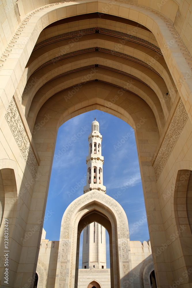 The Sultan Qaboos Grand Mosque in Muscat, Oman, with arches and the minaret
