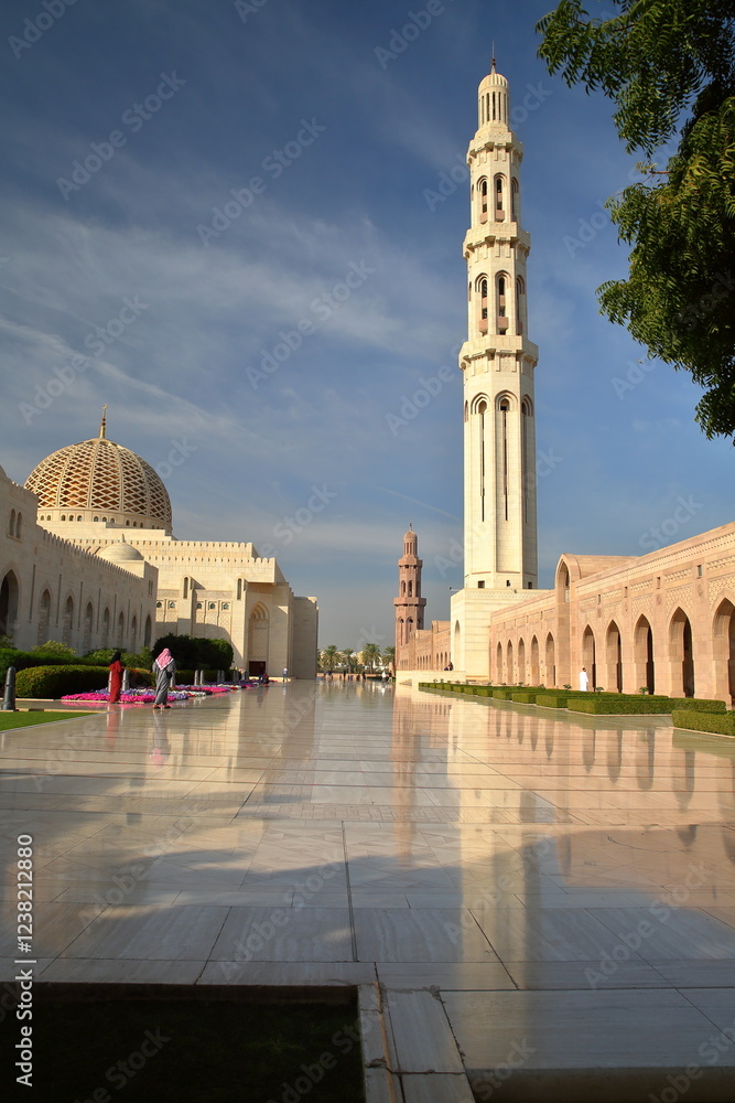 The Sultan Qaboos Grand Mosque in Muscat, Oman, with patterned tiles and reflections