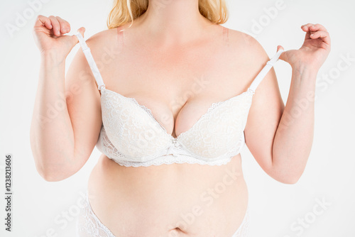 Large natural saggy breasts after breastfeeding in a lace push-up bra close-up, big boobs on white background, augmentation and plastic surgery concept photo