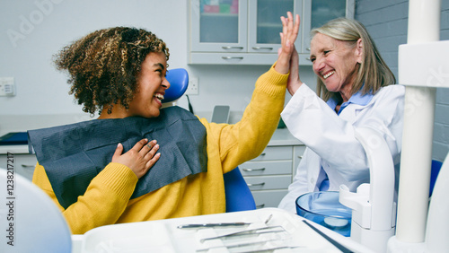 Happy Patient High-Fiving Dentist After a Successful Dental Exam in Office