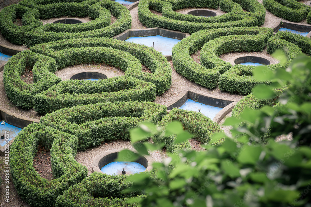 Formal Garden with Sculpted Hedges and Water Features.
