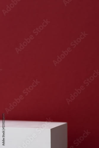 Geometric white scene on a burgundy background. A premium podium for advertising and presentation of your product. Showcase, display case.