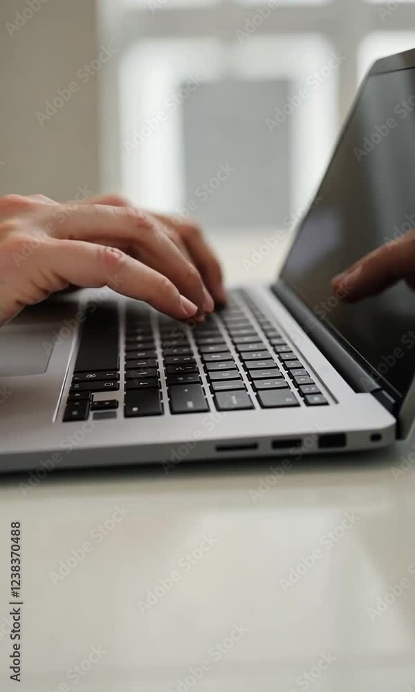 Close-Up of Hands Typing on a Laptop Keyboard in a Modern Workspace Close-Up of Hands Typing on a Laptop Keyboard in a Modern Workspace