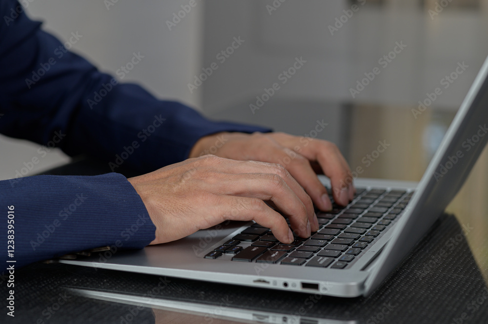 Professional Hands Typing on Laptop Keyboard in Modern Workspace Professional Hands Typing on Laptop Keyboard in Modern Workspace