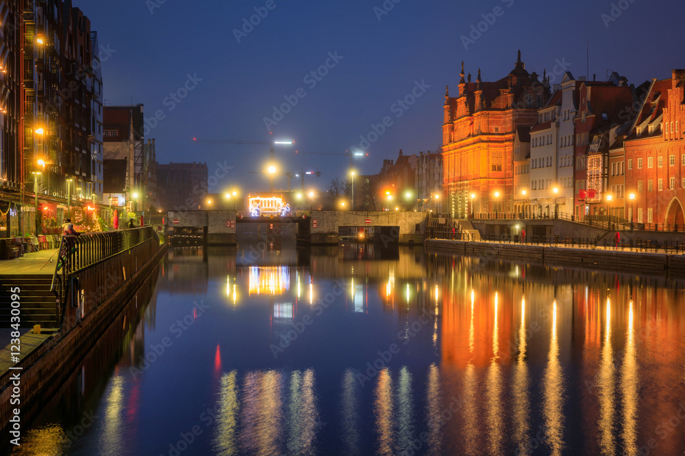 Beautiful architecture of the old town in Gdansk by the Motława river with a historic port crane at wintery night. Poland Beautiful architecture of the old town in Gdansk by the Motława river with a historic port crane at wintery night. Poland