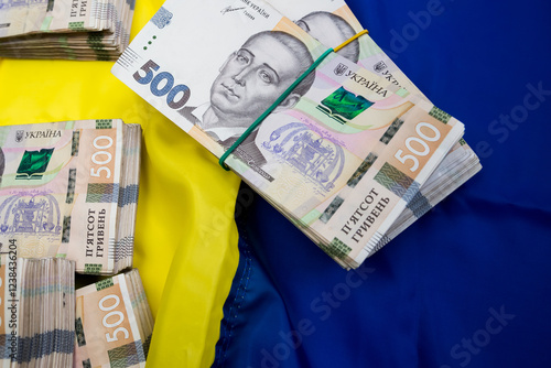 Ukrainian Money on national flag blue yellow, finance conccept. photo