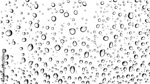 Closeup of a transparent water droplet on a glass surface showcasing the refractive and reflective properties of the liquid