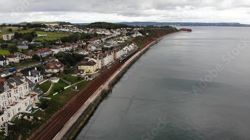 Wallpaper Mural Aerial view of a train passing along the coast in Dawlish, a seaside town in Devon, UK, showing the railway line built on the sea wall Torontodigital.ca