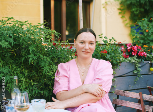 Portrait of middle age 40 - 45 year old woman relaxing in outdoor cafe photo