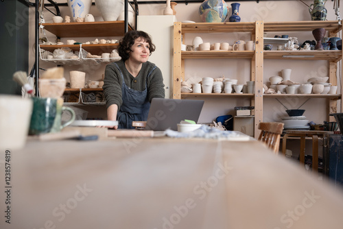 Woman starting a craft business looking out of the woman planning her growth photo