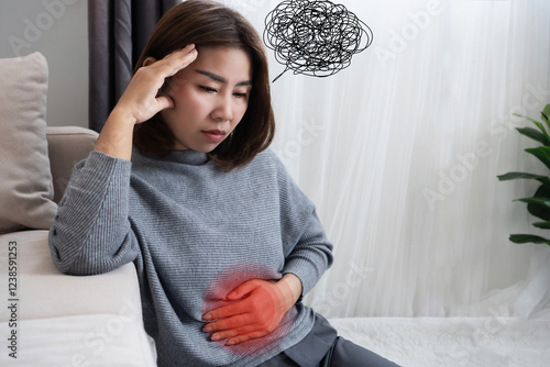 Obraz na plátně Asian woman suffering from nervous stomach, gut brain axis , feeling discomfort,