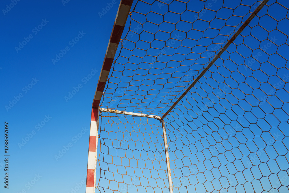 Close-up textured soccer net on soccer goal isolated on free blue backgrund. Close-up textured soccer net on soccer goal isolated on free blue backgrund.