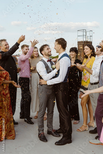 Guests throwing confetti on newly married gay couple