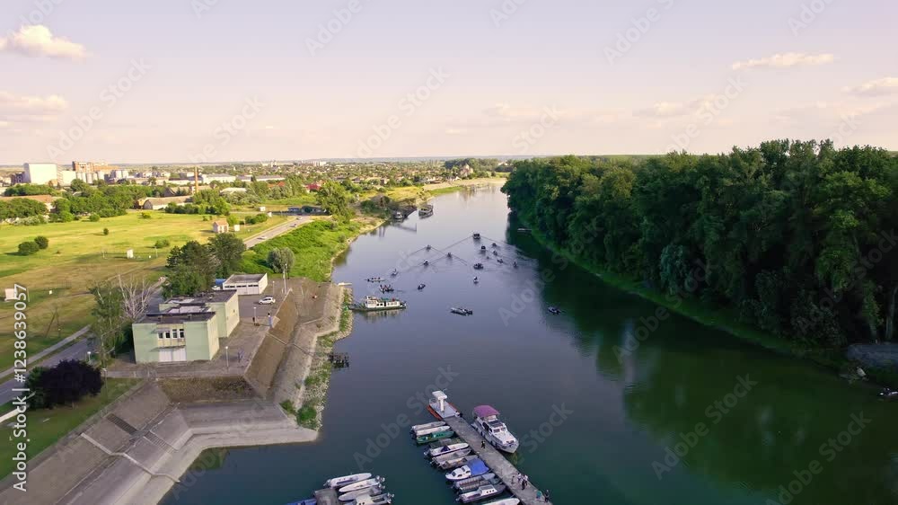 View of a serene river with boats and lush greenery on a sunny day View of a serene river with boats and lush greenery on a sunny day