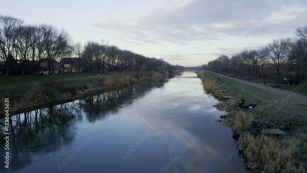 Nature stroll along the river at dusk with reflections and tranquility in a serene landscape Nature stroll along the river at dusk with reflections and tranquility in a serene landscape
