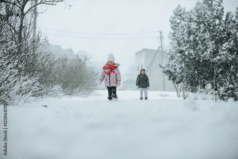 Girl Walking in Snowy Path with Boy Behind Girl Walking in Snowy Path with Boy Behind
