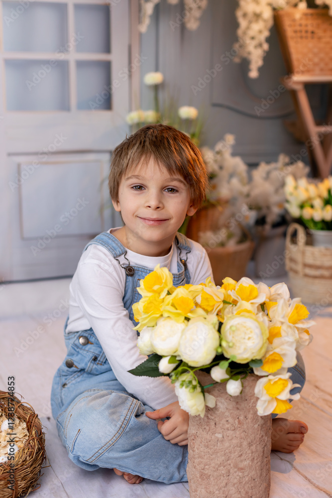Happy beautiful child, kid, playing with small beautiful knitted chick, spring flowers and bike Happy beautiful child, kid, playing with small beautiful knitted chick, spring flowers and bike