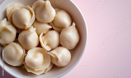 Elegant presentation of traditional Russian pelmeni in a pastel dish photo