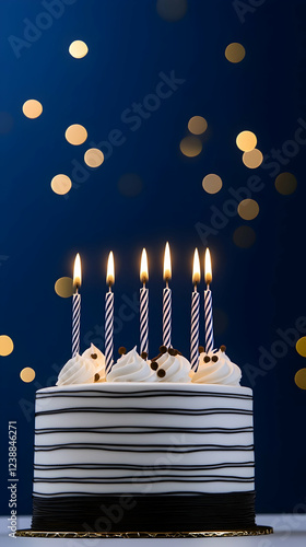 Birthday cake with lit candles, blue background, bokeh lights, celebration