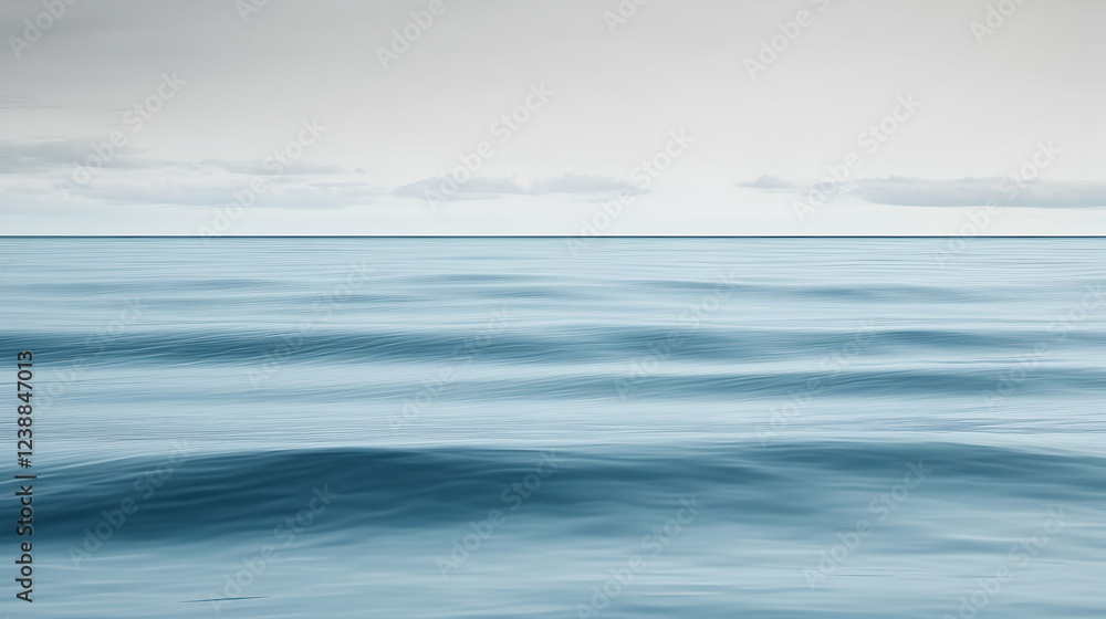 Fototapeta premium Calm ocean waves under a cloudy sky; serene seascape for travel brochure