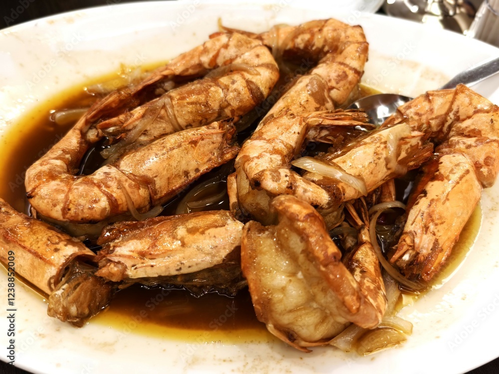 A serving of fried butter shrimp seasoned with garlic and other spices A serving of fried butter shrimp seasoned with garlic and other spices