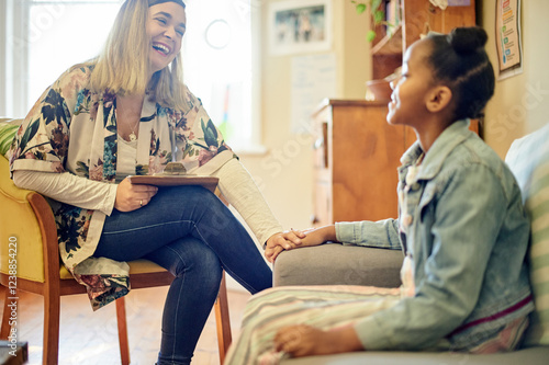 Φωτογραφία Girl child, therapist and talk for mental health with psychology expert, woman or laughing with support