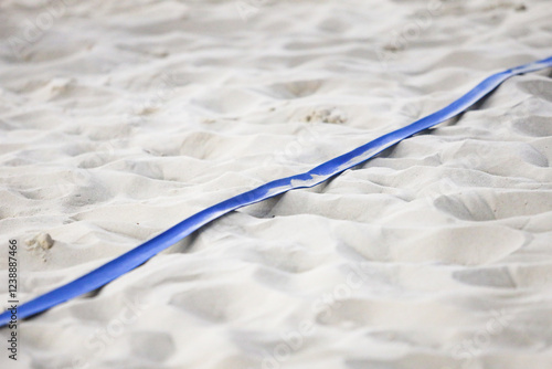 Indoor Beach Volleyball Game Court Blue side line with sand. Photo taken in indoor arena.