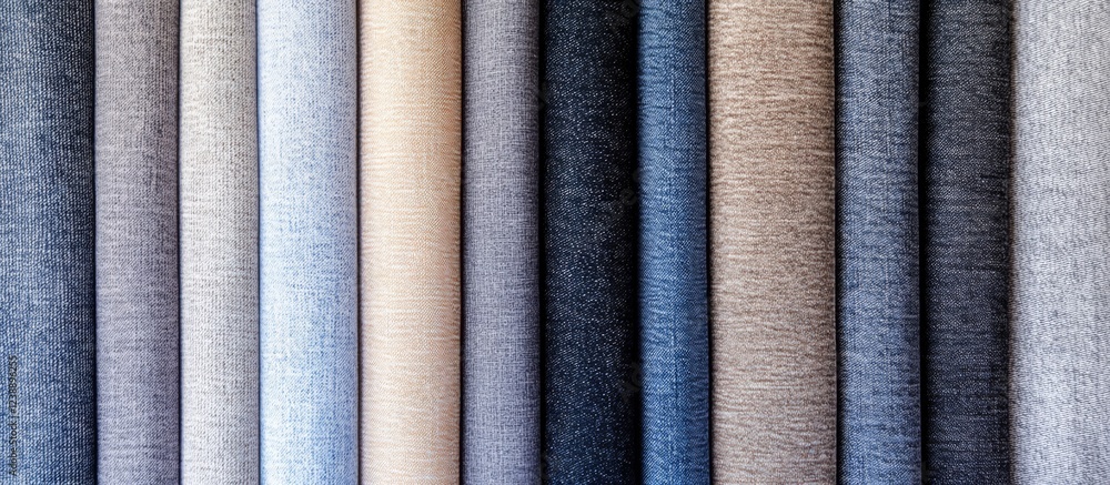 Rolls of textile fabric in various neutral colors in vertical arrangement Rolls of textile fabric in various neutral colors in vertical arrangement