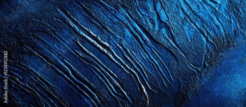Abstract textured blue background with organic wavy patterns and subtle lighting effects